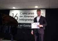 El saxofonista saguntino Enric Lozano Carpena con el diploma que le acredita con este premio