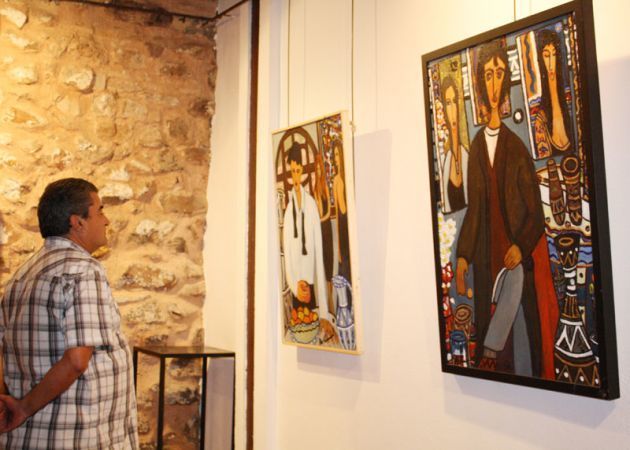 Un visitante observa uno de los cuadros expuestos